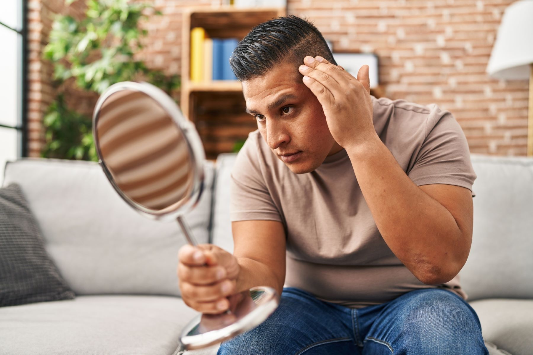 Man checking out his hairline appearance