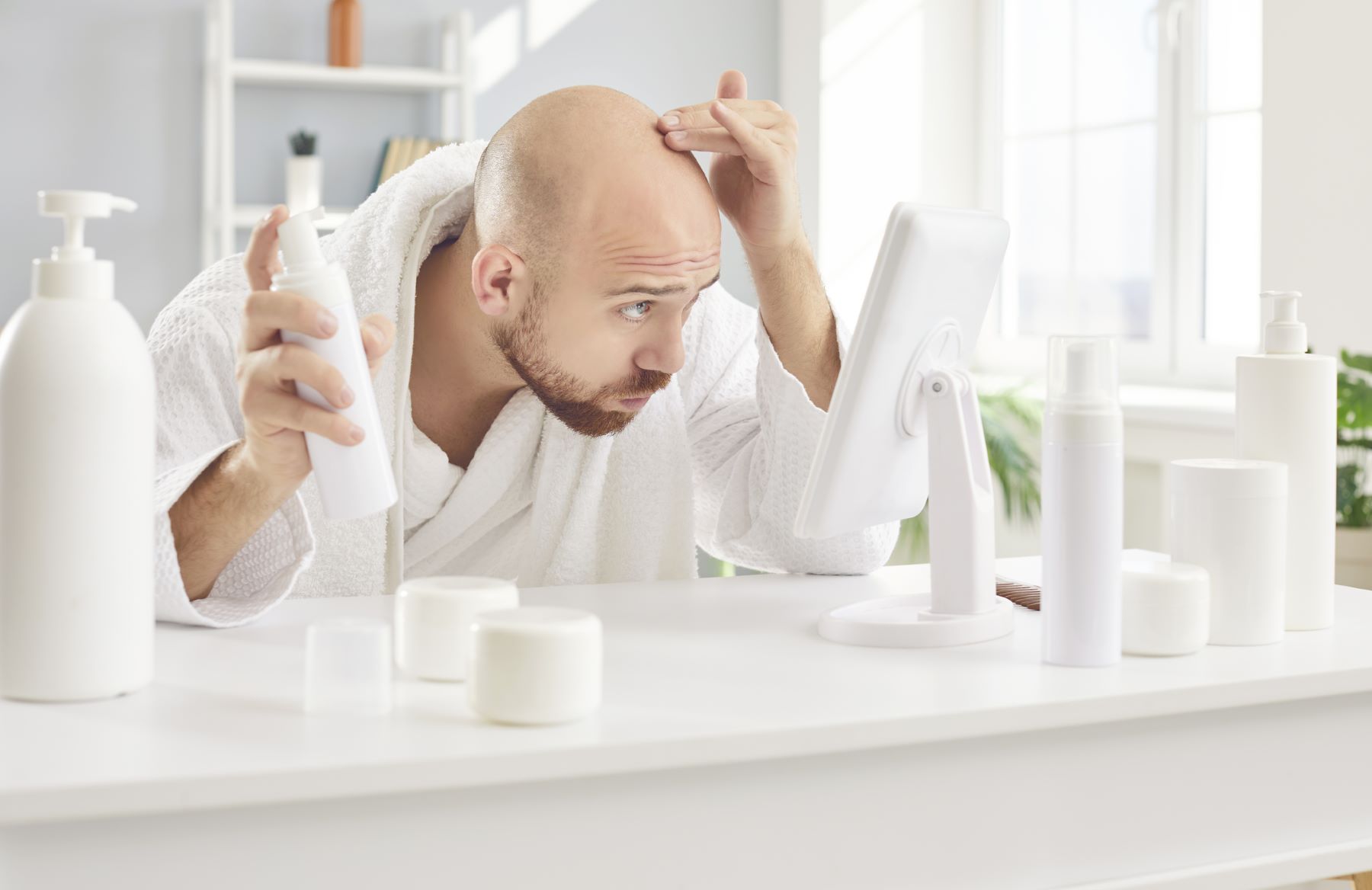 Man using Minoxidil and Finasteride for hair loss