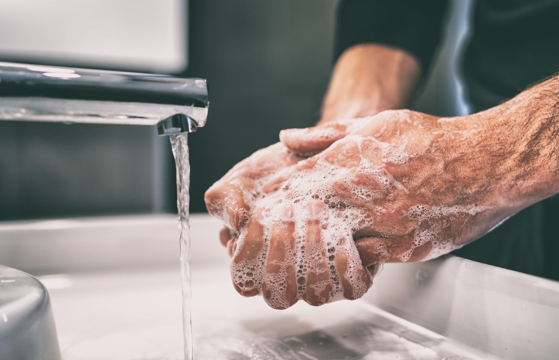 Man washing hands after applying Minoxidil