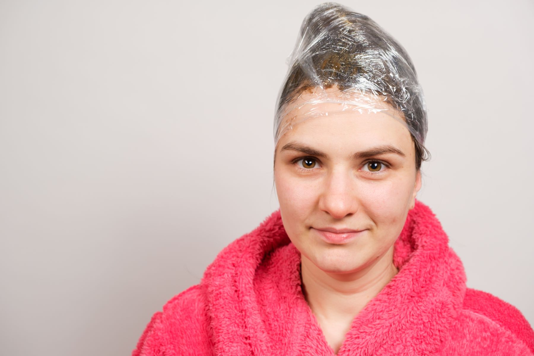 Woman leaving olive oil mask in her hair