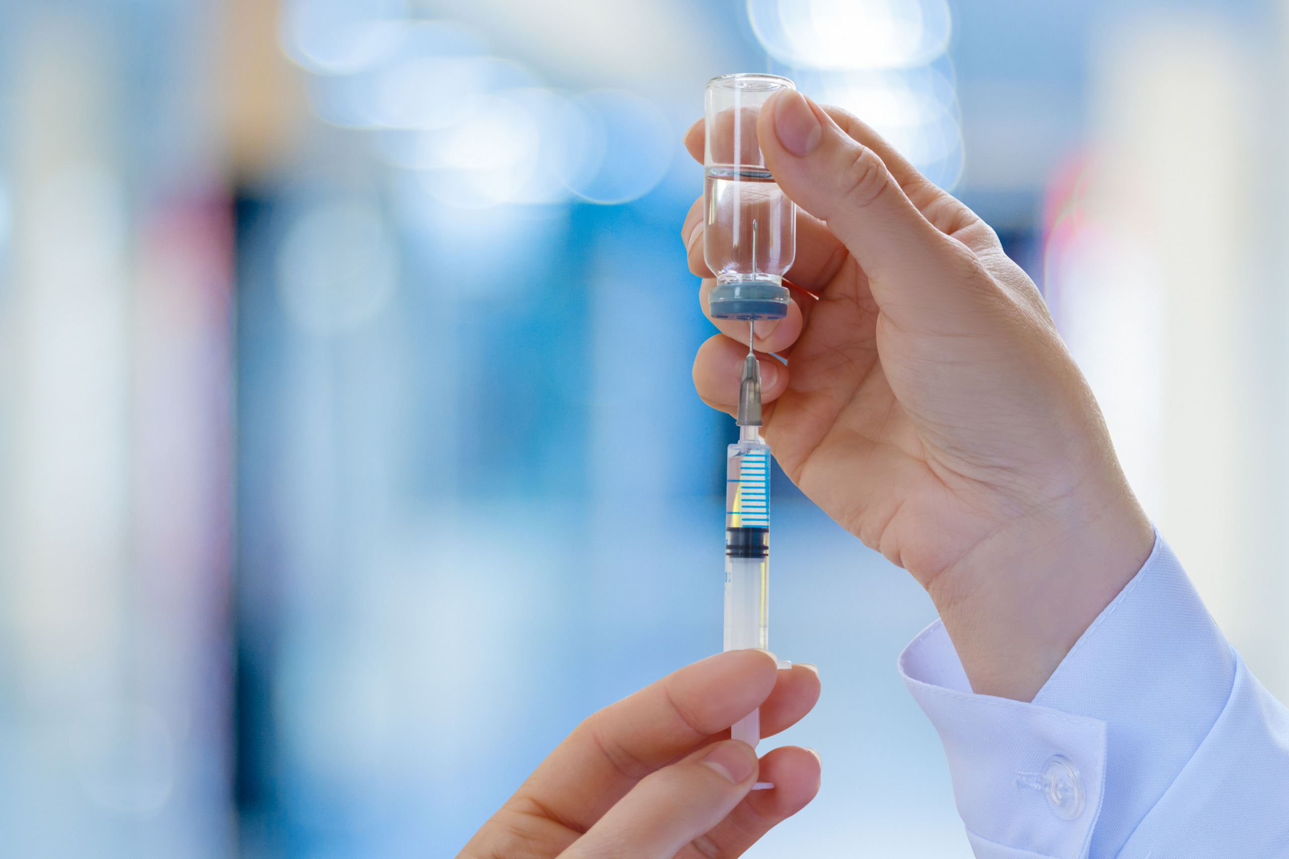 syringe being filled with a vaccine