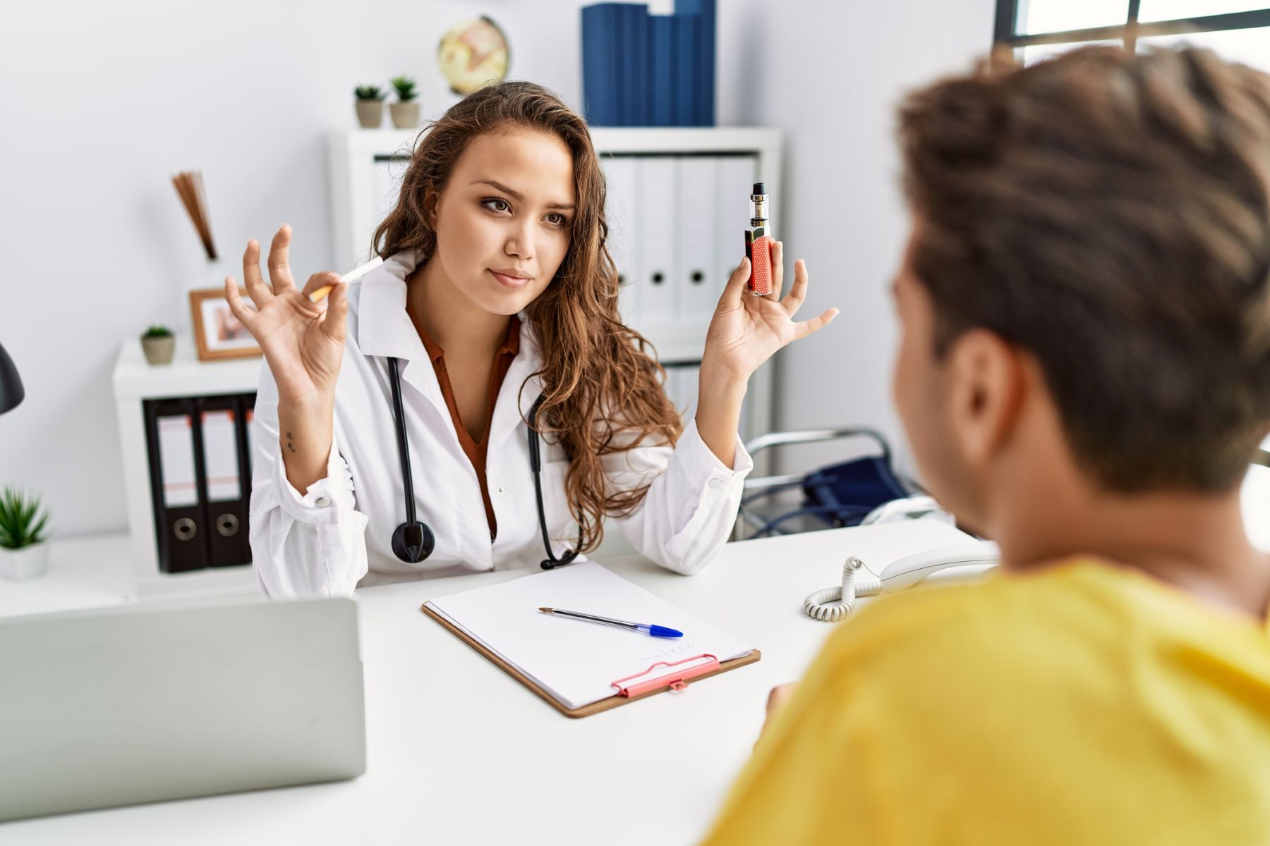 Doctor comparing vaping health effects to those of smoking