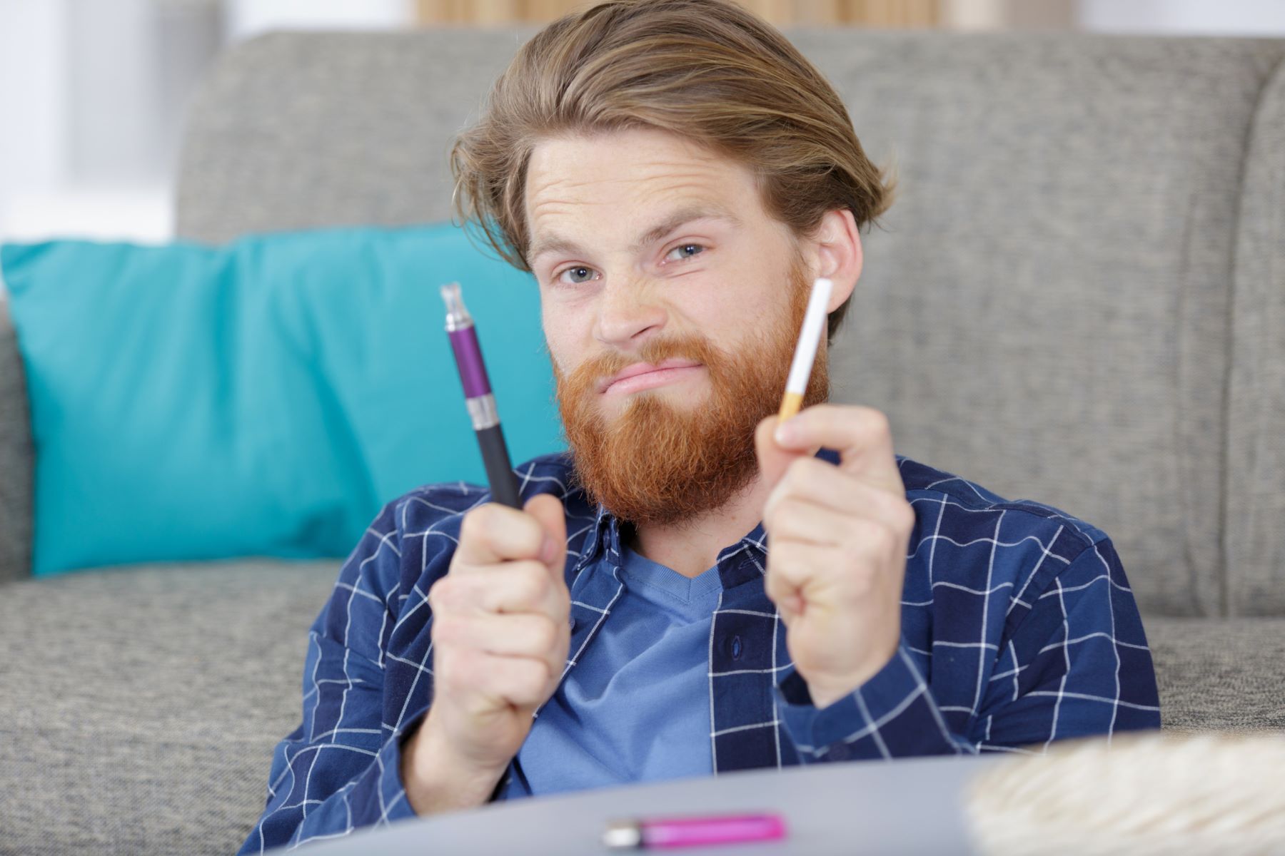 Man wondering if vapes cause less hair loss than cigarettes