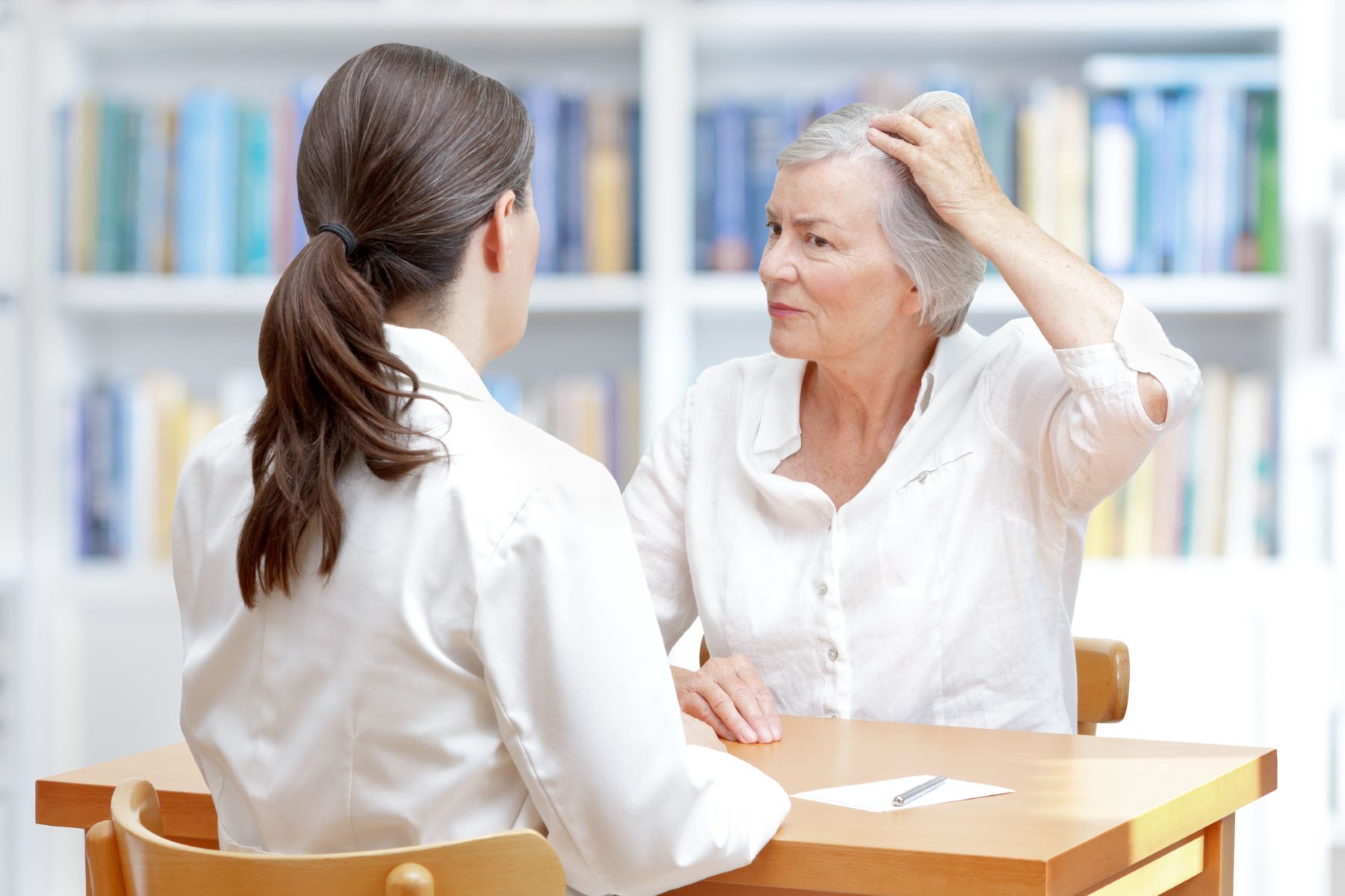 Woman concerned about hair loss seeing hair doctor