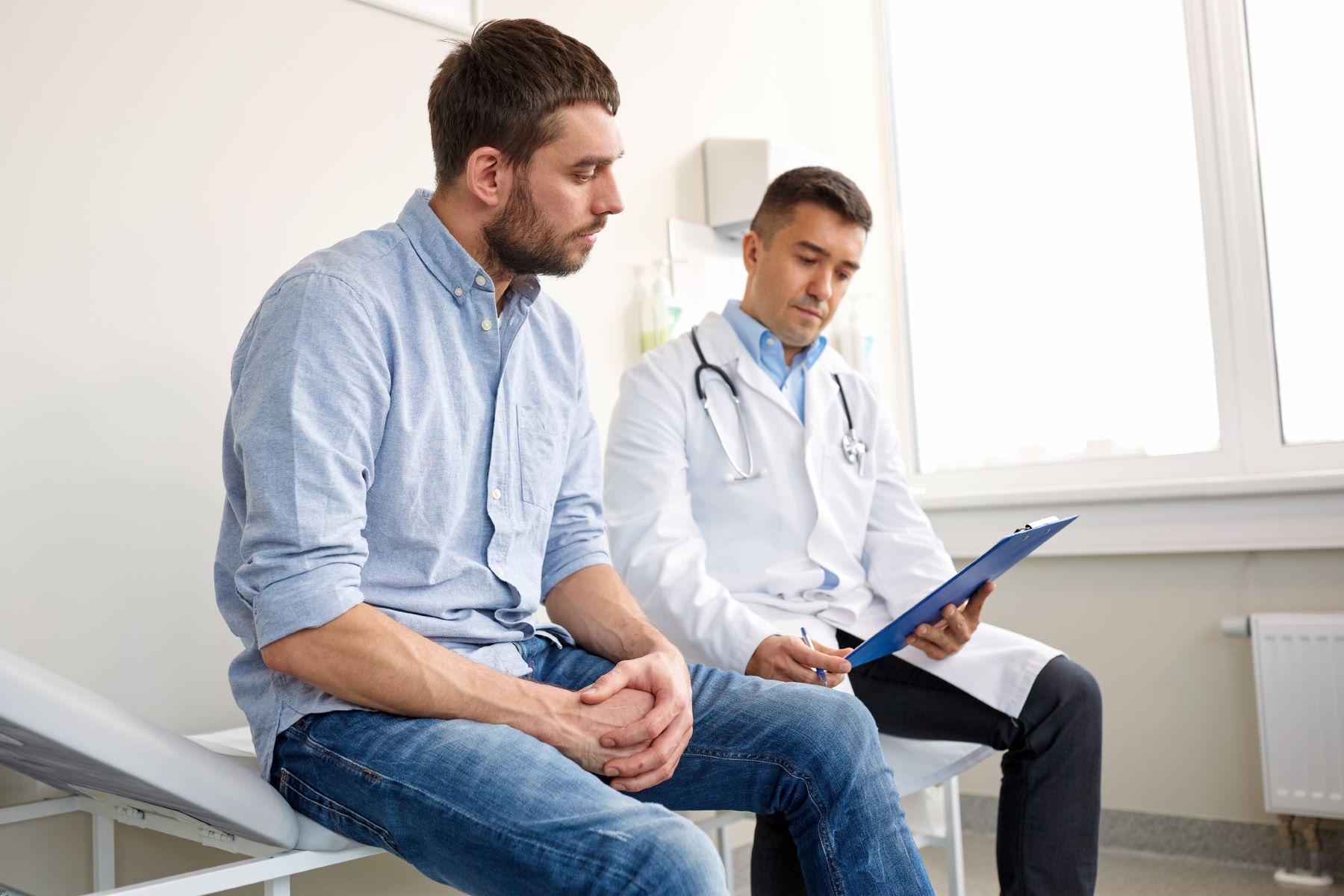 Male patient consulting with doctor about beard hair loss