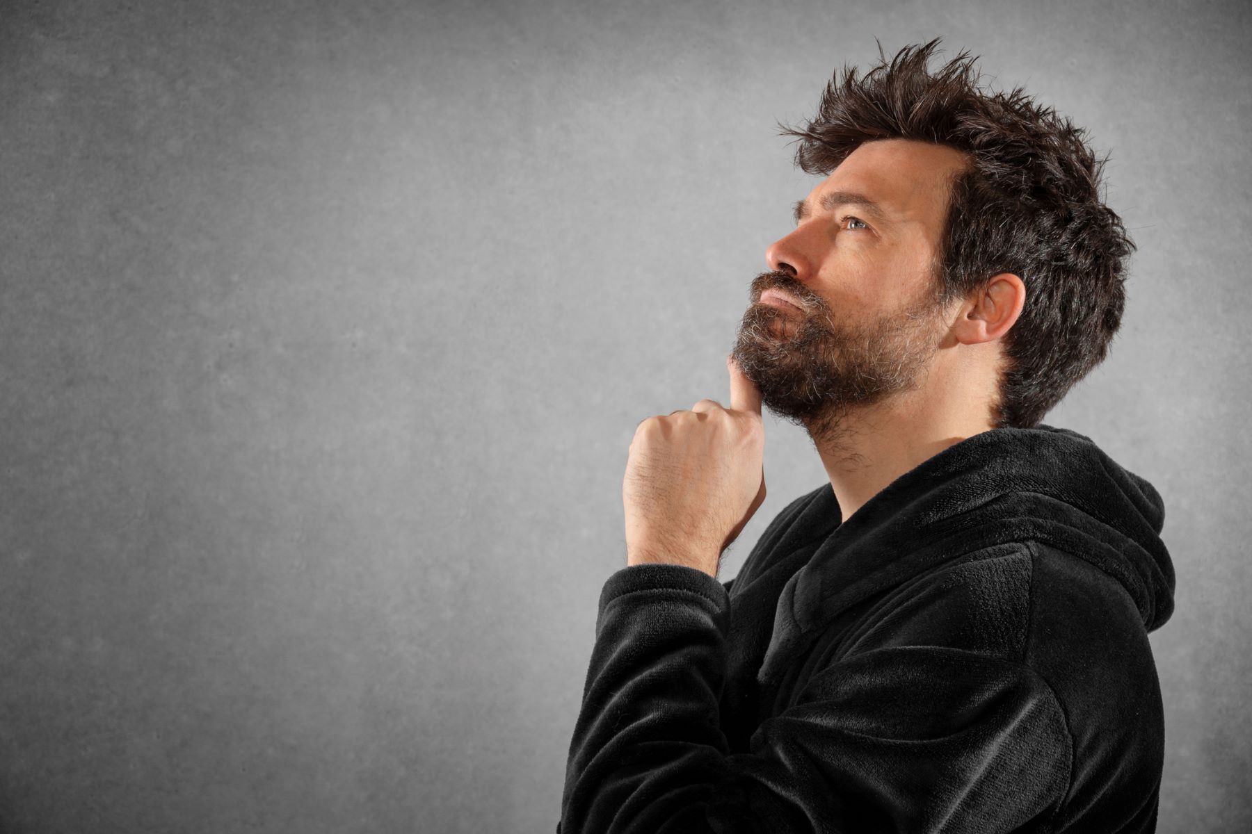 Man pondering how often to trim his beard