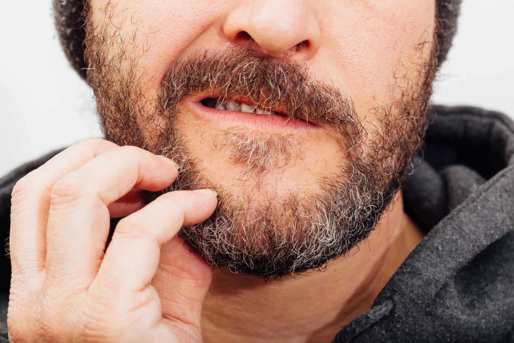 Man scratching his beard