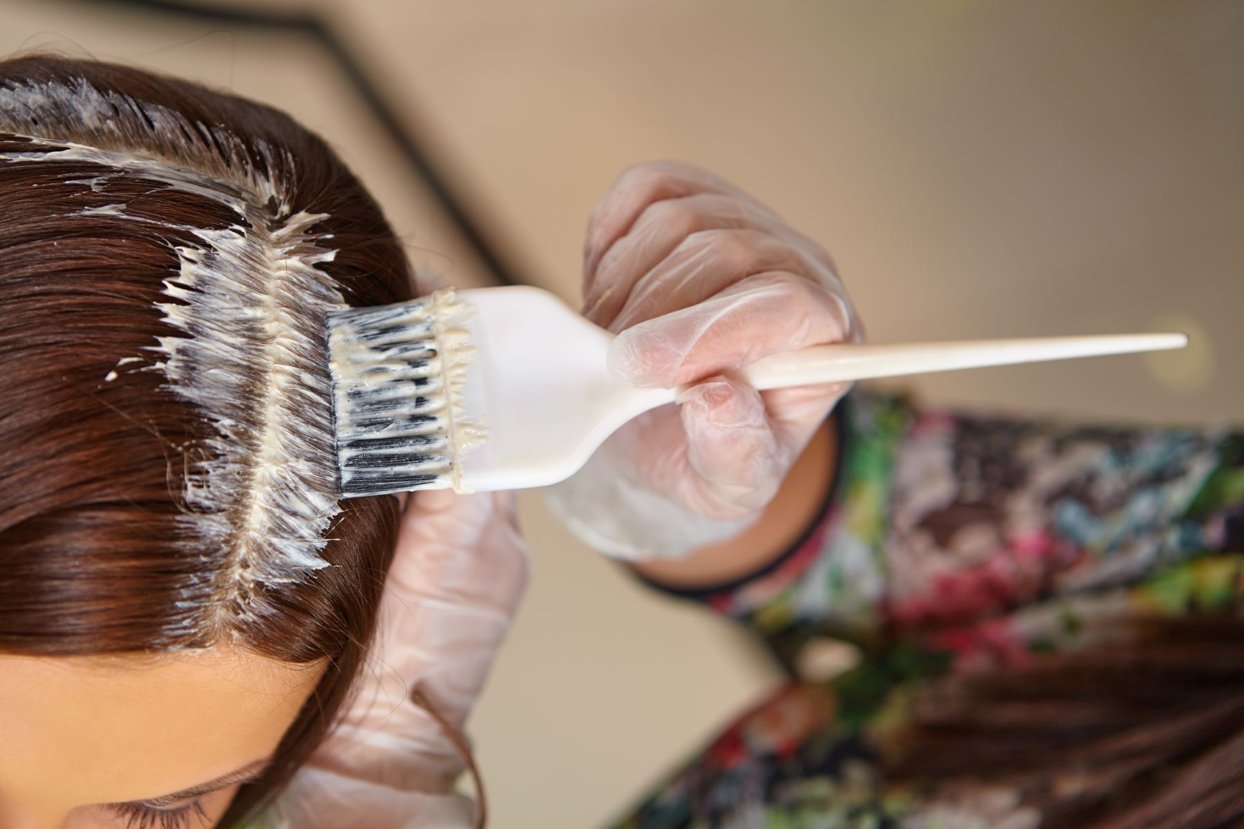 Woman applying a hair product with harsh chemicals