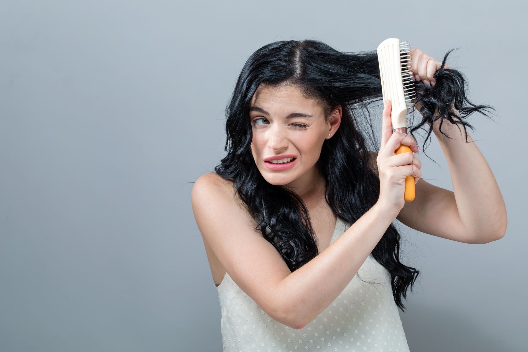 Woman with damaged and tangled 2a hair