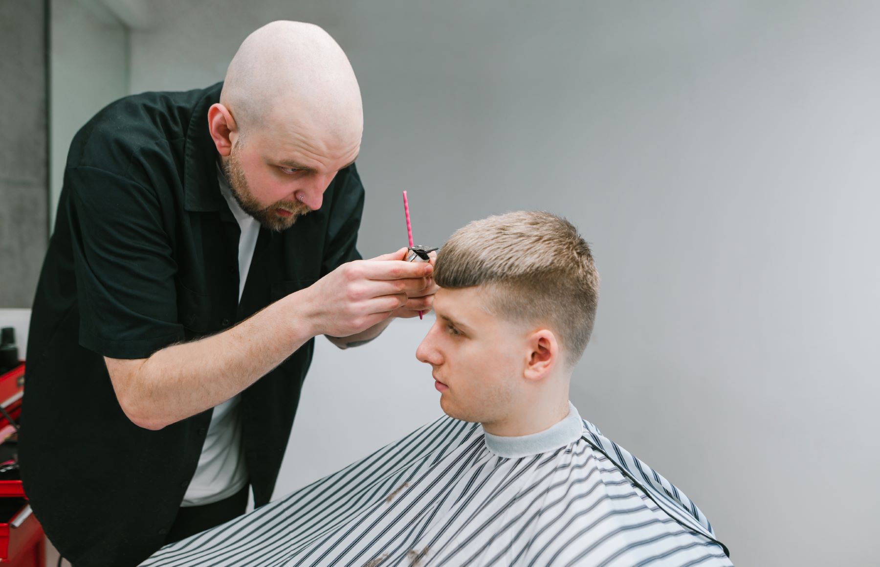 Barber cutting in a French crop