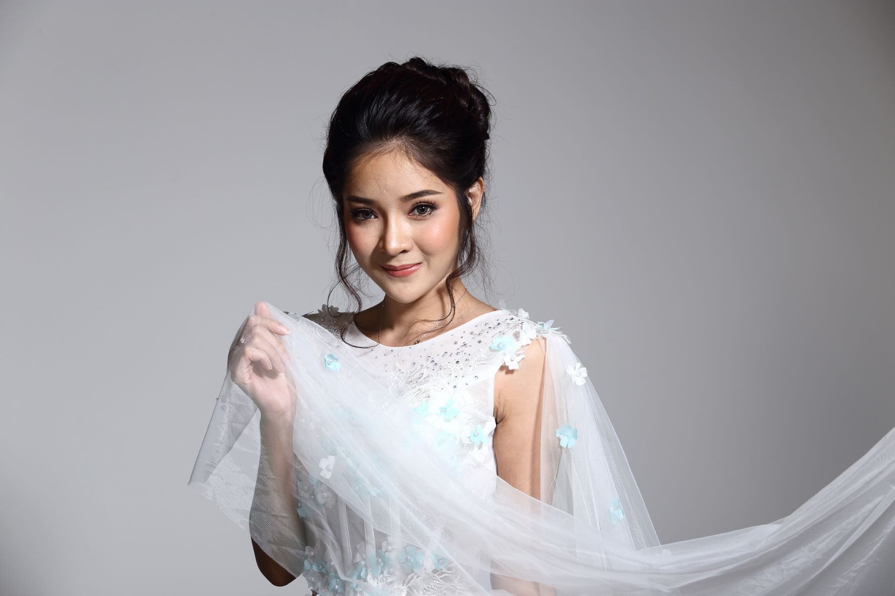 Bride with a teased updo with face-framing tendrils