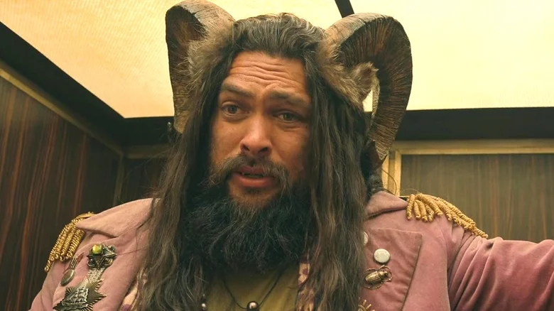 Jason Momoa, with a full beard, as a fantastic character