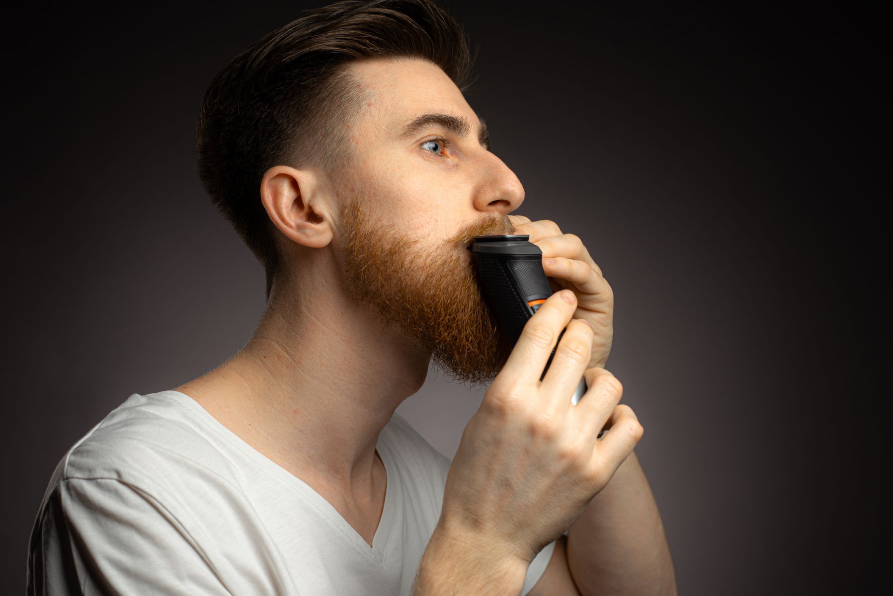 Man grooming his full beard