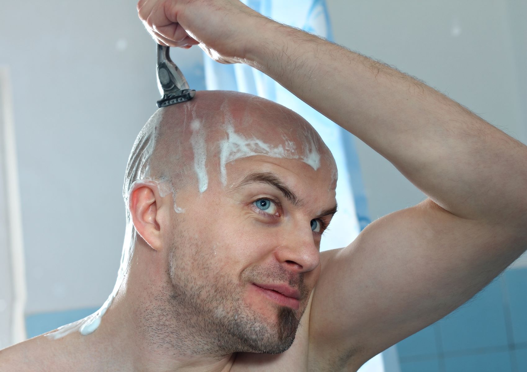 Man shaving his head