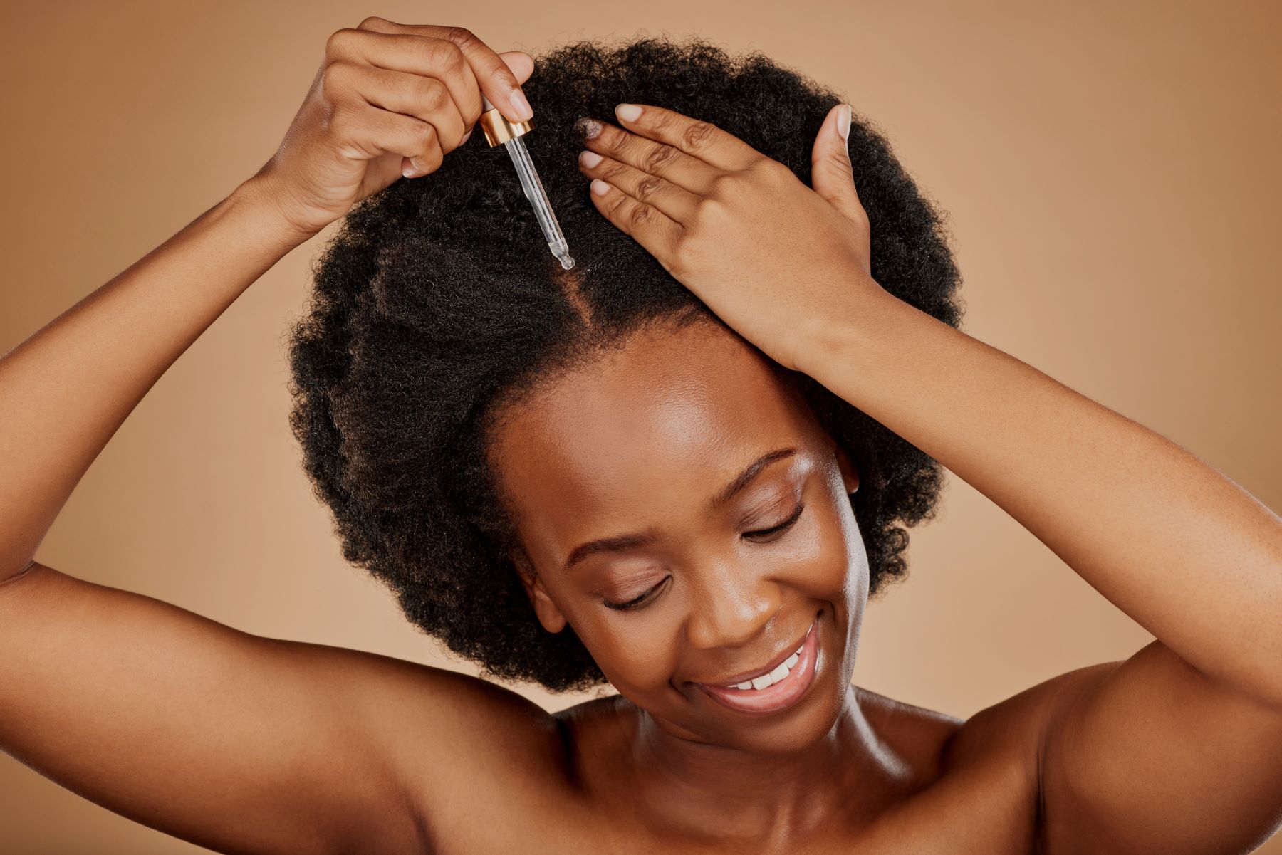 Woman applying hair oil