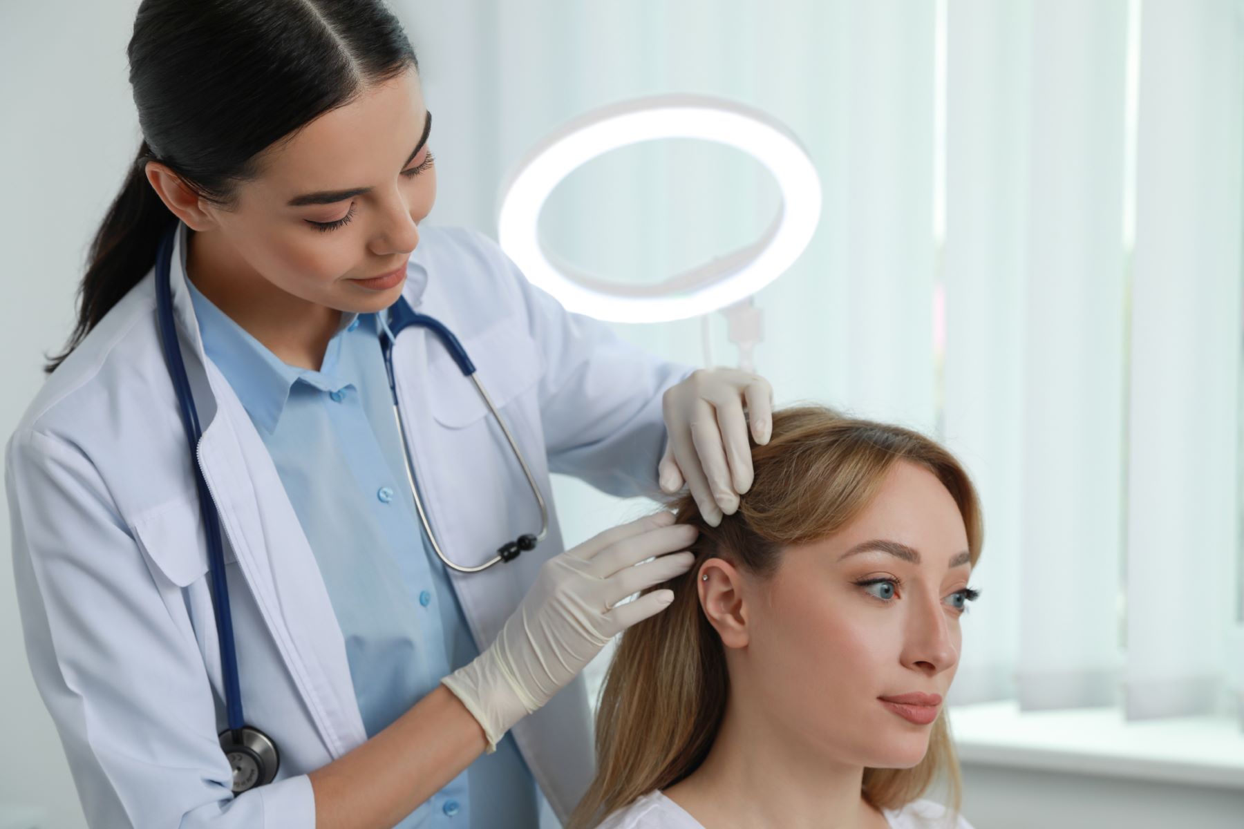 Woman getting her hair loss diagnosed