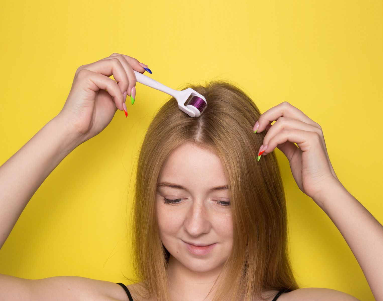 Woman using a derma roller