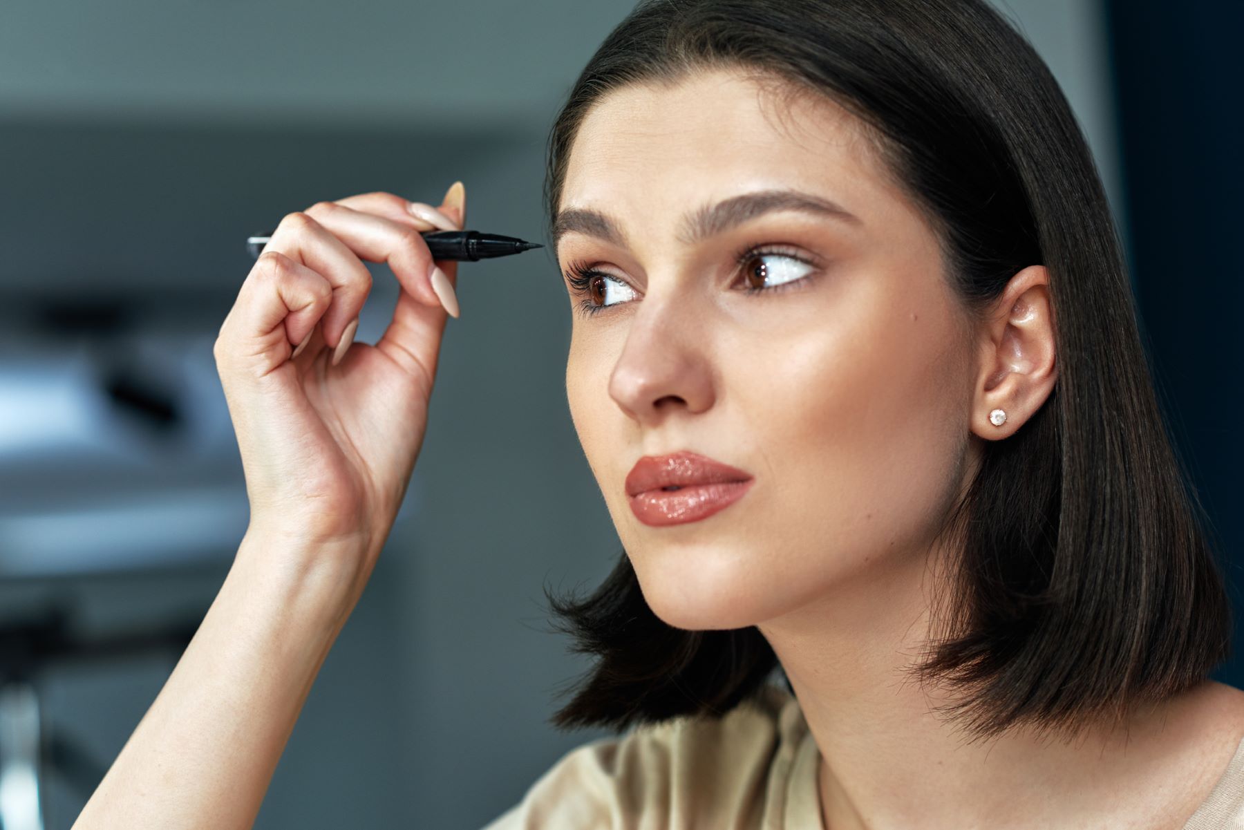 Woman using an eyebrow pen