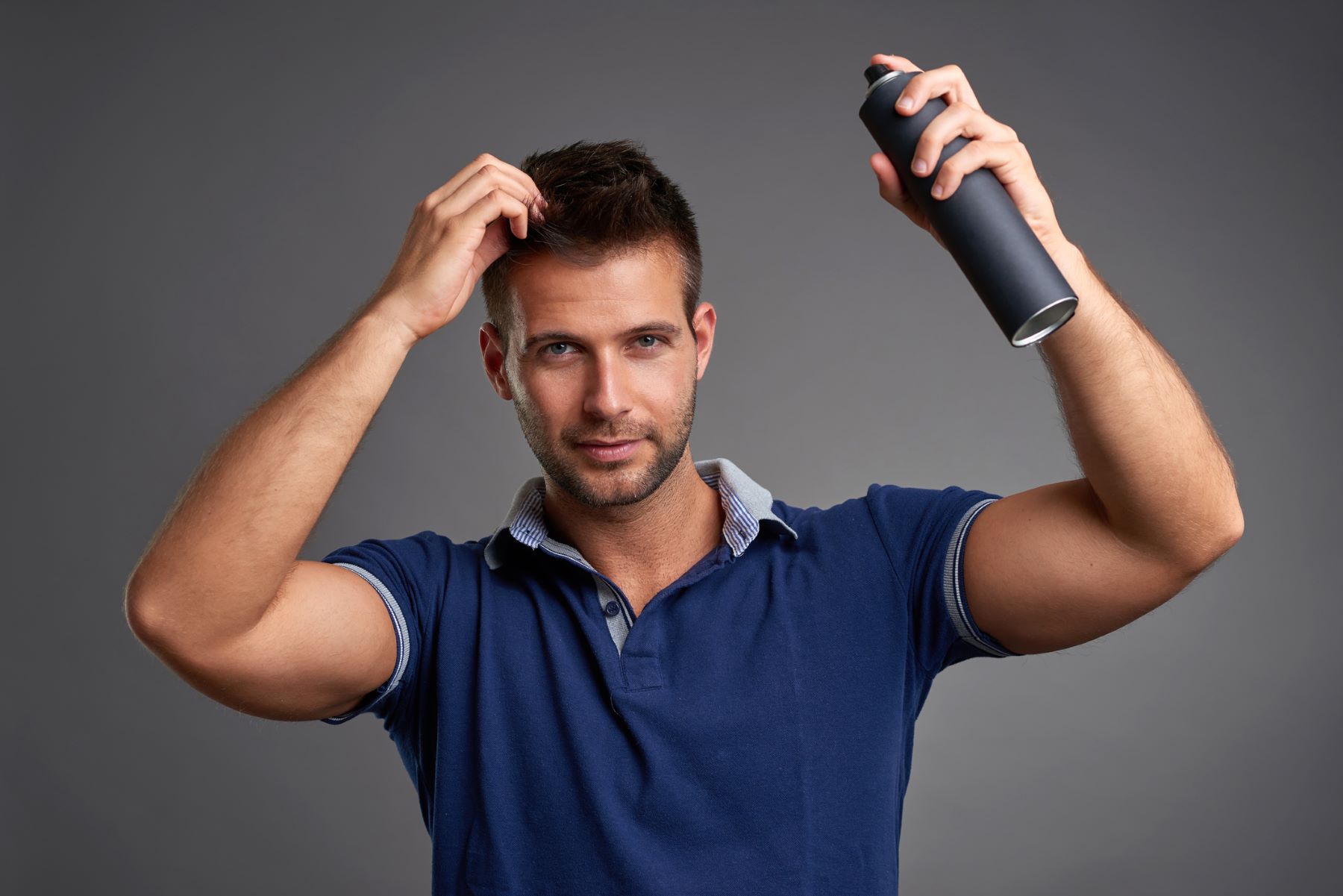 Man using hair thickening spray