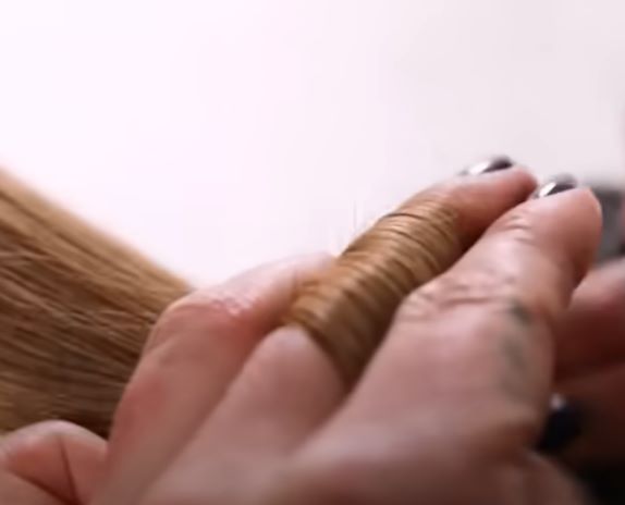 Woman preparing to dust her split ends