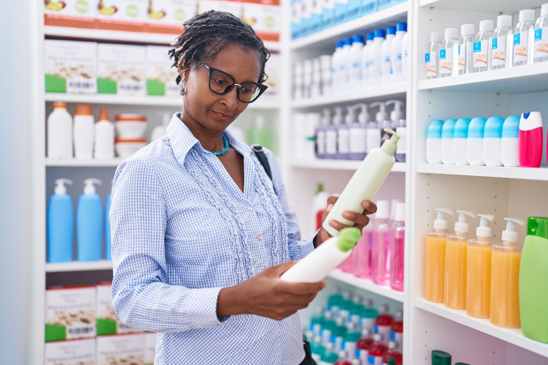 woman checking shampoo for harsh chemicals