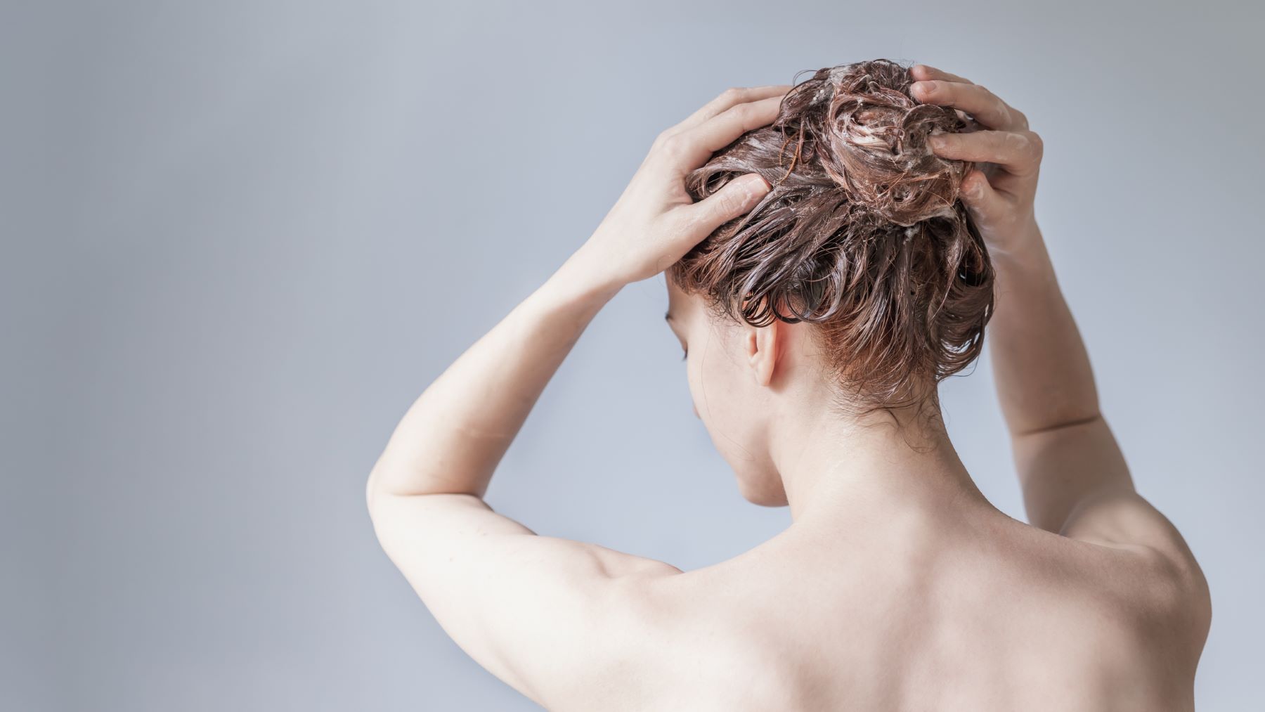 Woman using shampoo