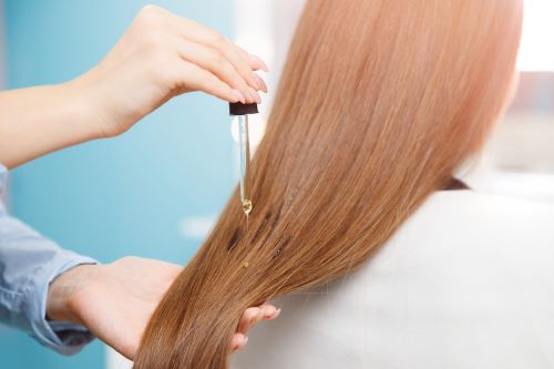 Applying pumpkin seed oil through the lengths of the hair