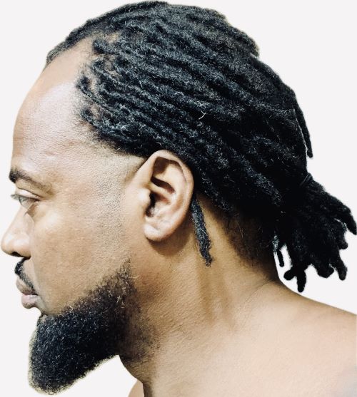 Black man with a receding hairline wearing braids