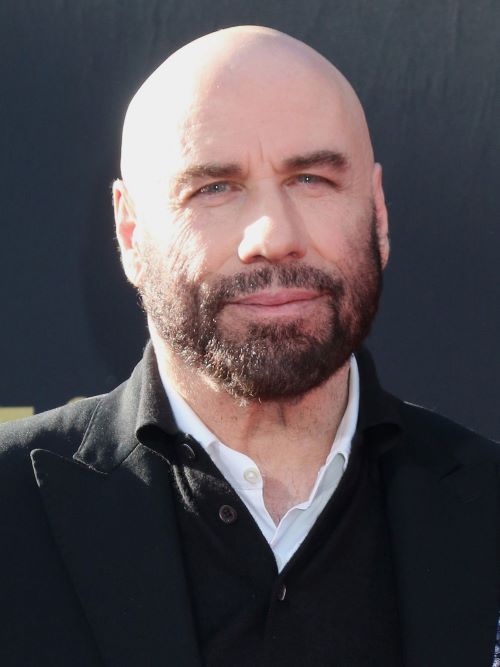 John Travolta embracing his hair loss by going bald with a beard