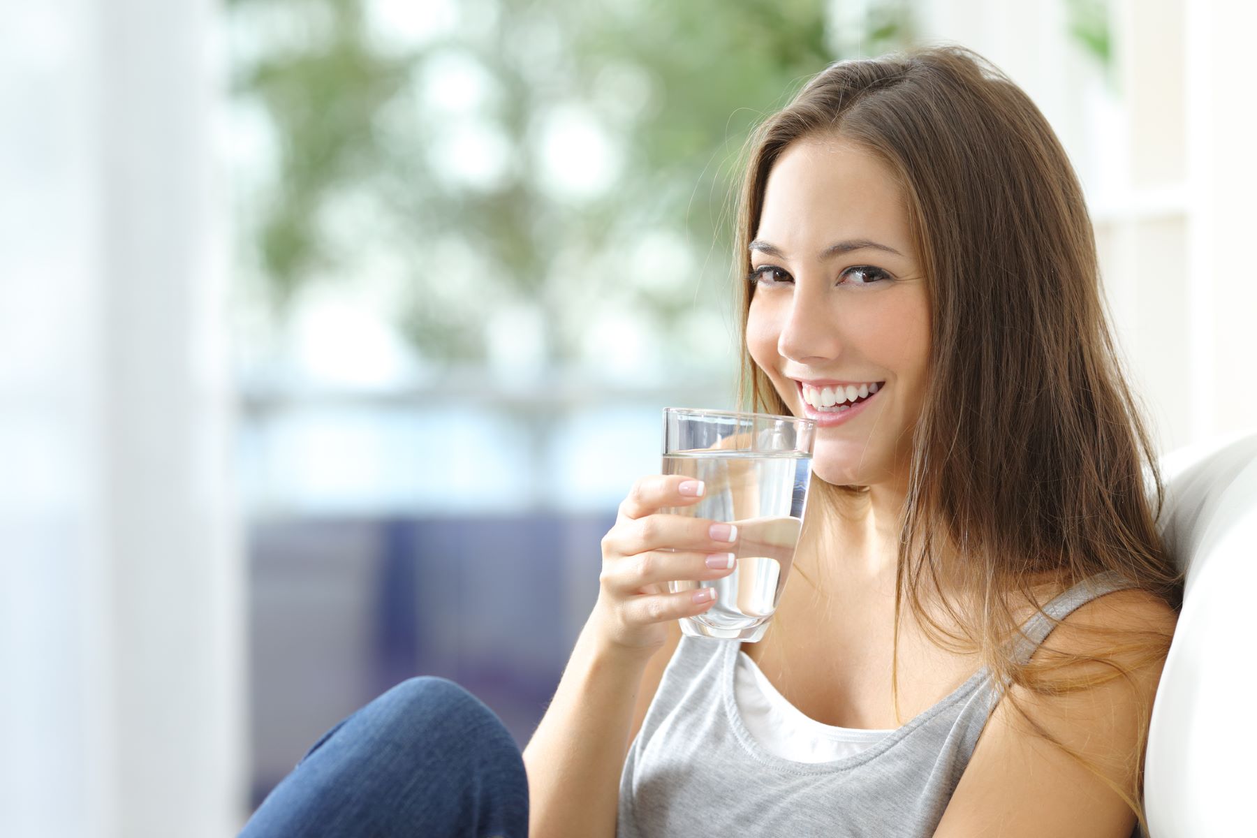 Woman drinking water to stay well-hydrated