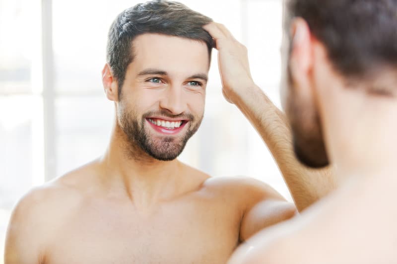 Man Admiring Successful Hair Transplant