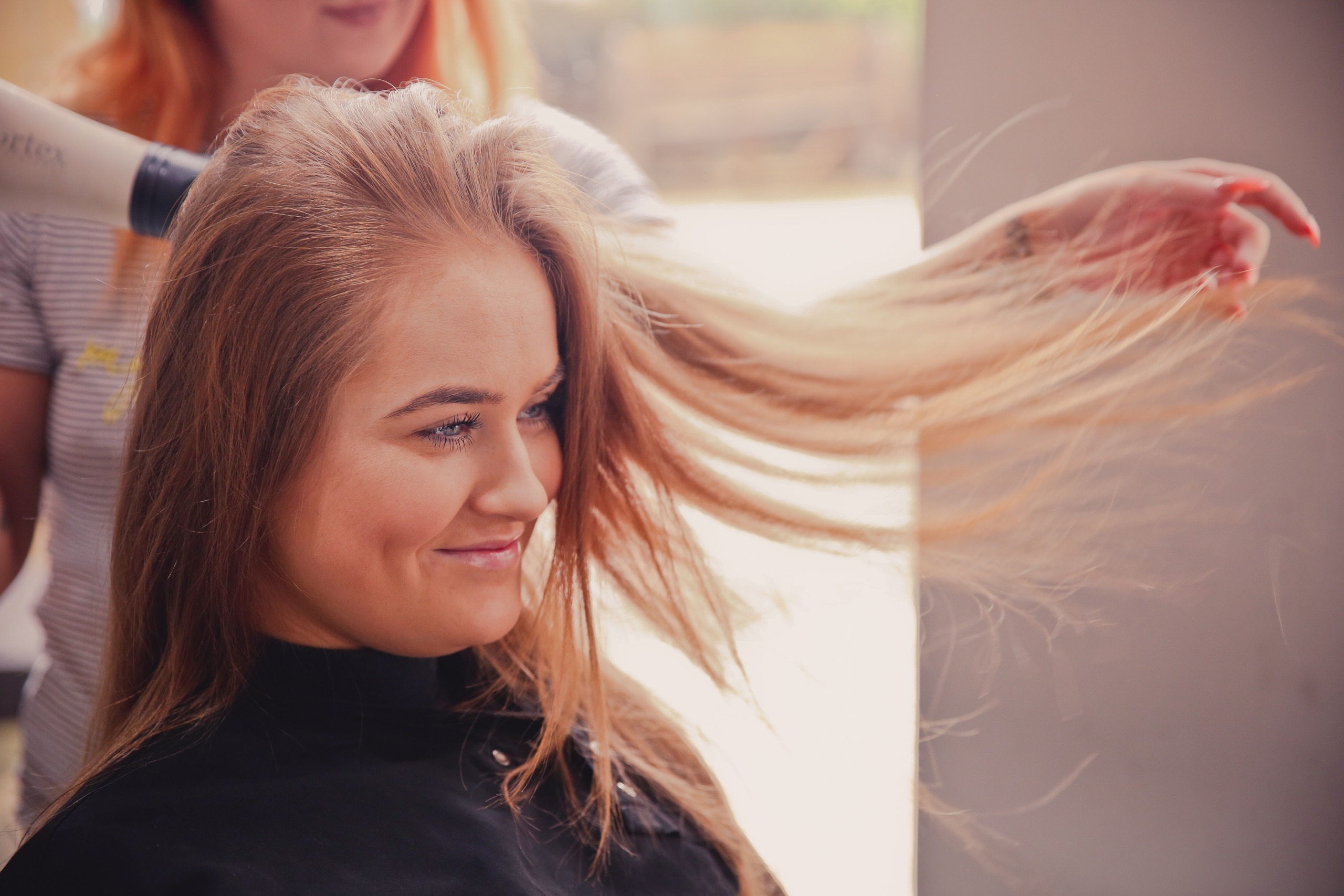 woman getting her hair blow-dried